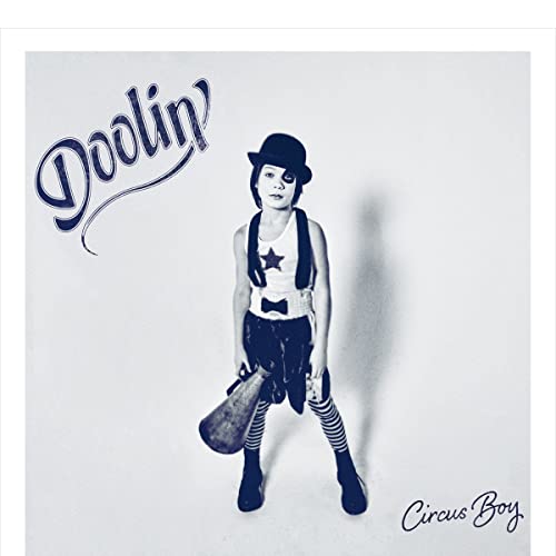 CD cover: young boy in circus attire, black and white photo.