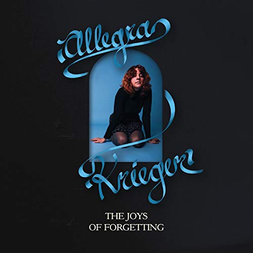 Vinyl album cover featuring a woman kneeling in a blue archway on a black background.
