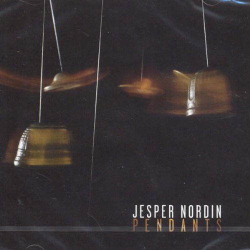 Dark album cover featuring blurred, hanging bell-shaped objects.