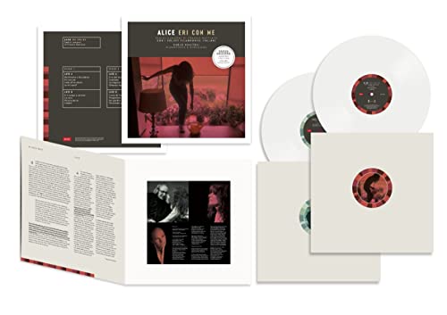 White vinyl record, album cover, and insert booklet laid out on a white surface.