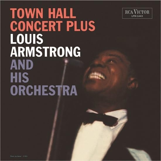 Louis Armstrong album cover, close-up of him singing into a microphone.