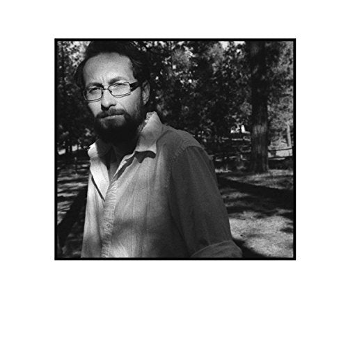 Black and white portrait of a man with glasses and a beard.
