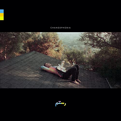 Album cover for Rostam’s “Changephobia” featuring a person lying on a rooftop.