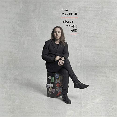 Tim Minchin album cover: man sitting on a vintage suitcase.