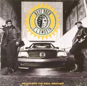 Vinyl album cover featuring two men standing beside a car with a yellow emblem.