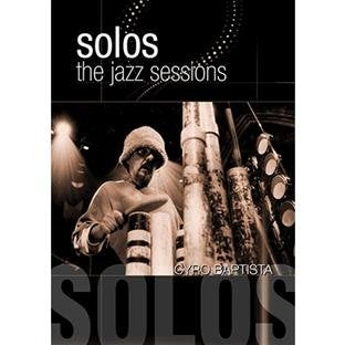 DVD cover with a man playing percussion, wearing a knit hat, under stage lights.
