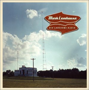 "Album cover with a radio tower and building under a cloudy sky."