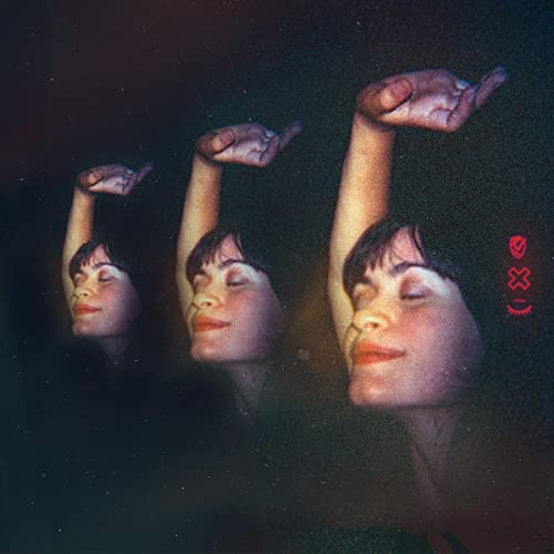 Triple exposure of a woman with eyes closed, arms raised, dark background.