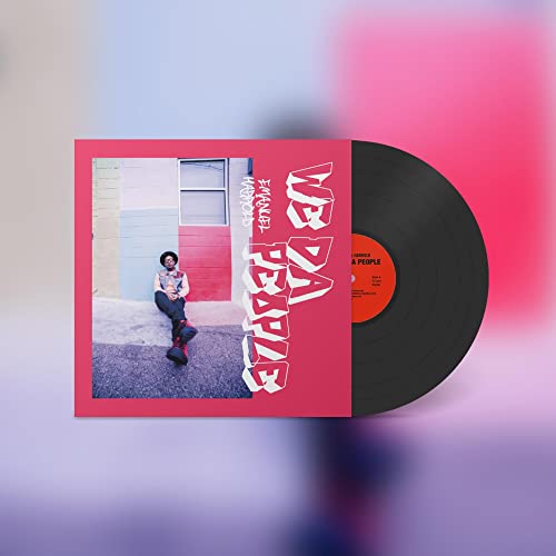 Vinyl record with red album cover featuring a person sitting down.