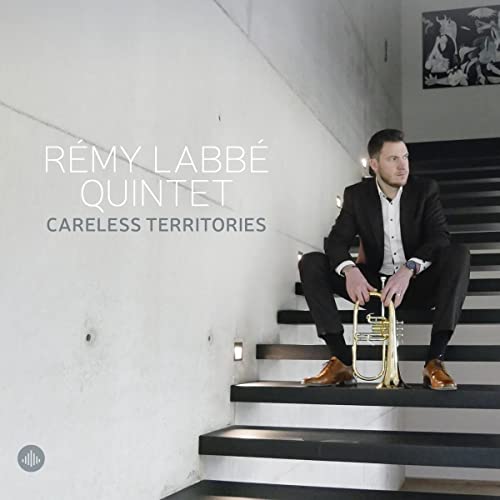 Rémy Labbé sits on stairs holding a trumpet, album cover art.
