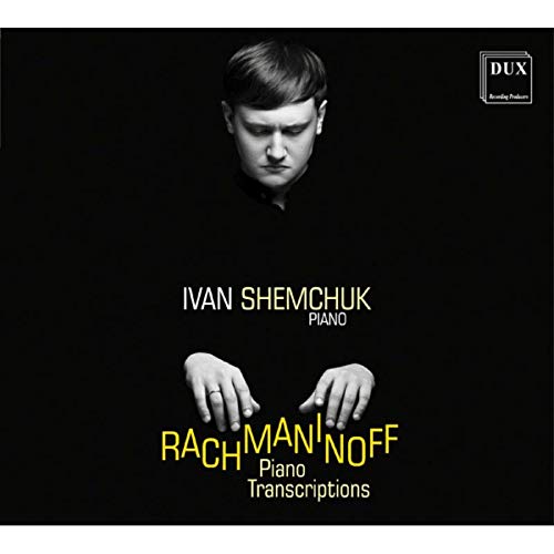 CD cover with a man looking down at his hands on a piano keyboard.