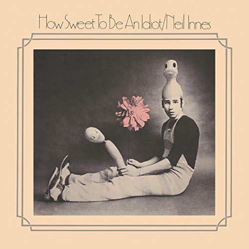 "Album cover with man wearing wooden head, holding a flower, on a peach background."