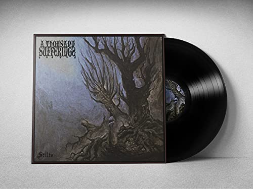 Vinyl record with album art depicting a dark, bare tree.