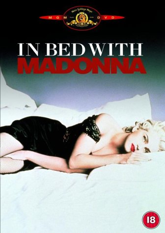 DVD cover featuring Madonna lying on a bed, wearing black lingerie, with title text above.