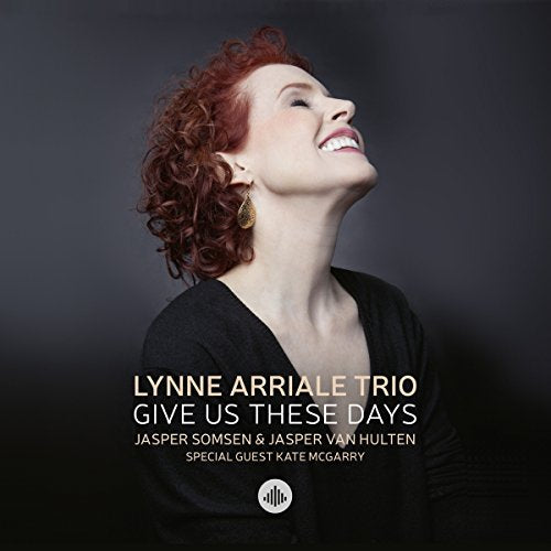 CD album cover featuring a smiling red-haired woman against a dark gray background.