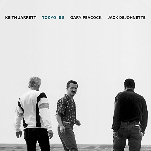"Album cover featuring three men standing near water, with names and title at top."