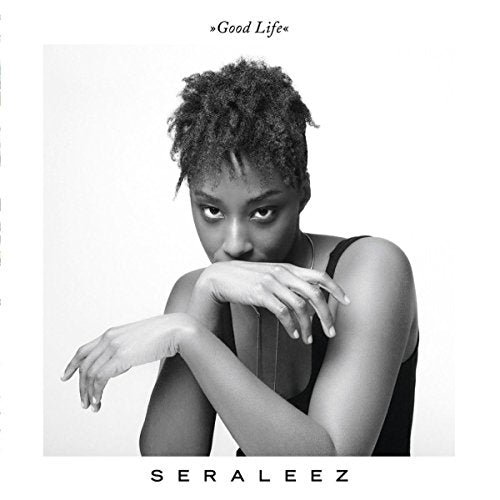 Black and white portrait of a woman with curly hair, album cover.
