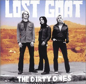 "Album cover with three men standing on a road in a desert landscape."