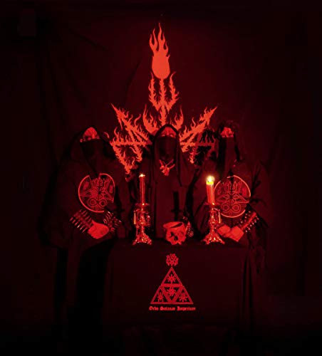 Three hooded figures in red light behind a table with candles and occult symbols.