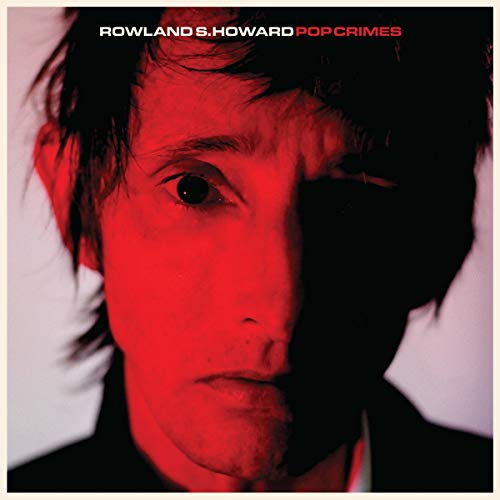 Close-up of Rowland S. Howard with red and black color scheme.