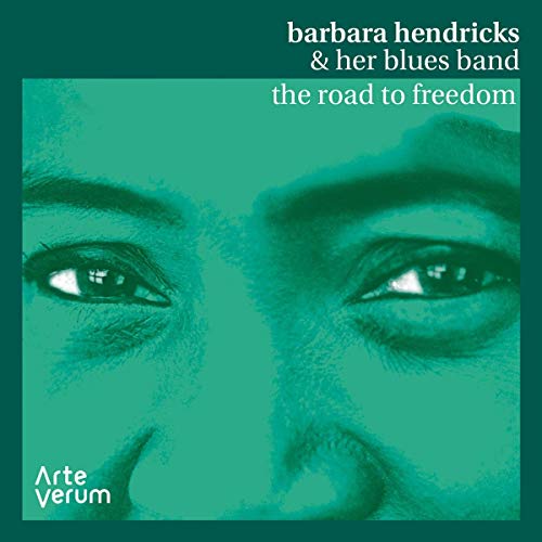 "CD cover with a green-toned close-up of a man's face and white text."