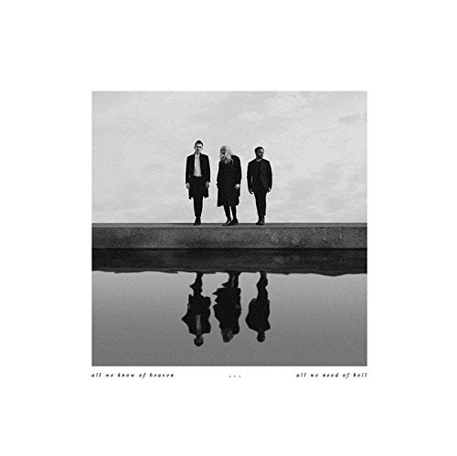 Black and white vinyl album cover featuring three men standing on a concrete ledge.