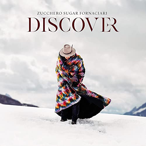Zucchero album cover: man in hat and colorful coat on snow.