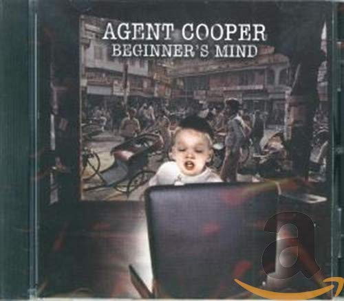 CD cover: baby’s face superimposed on a street scene, black chair.