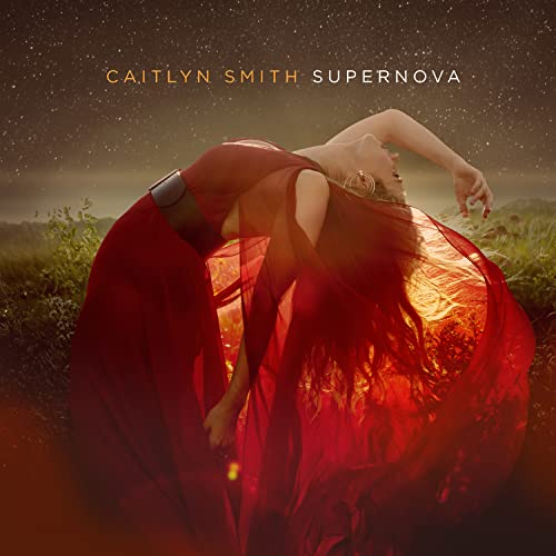 Vinyl album cover: woman in red dress against a fiery, starry sky.