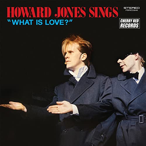 Howard Jones album cover featuring two men in suits, dark background.