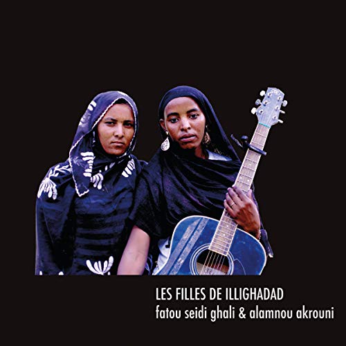 Two women with headscarves and a guitar on a black background.