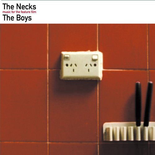 "Album cover with red tiles, white outlet, and black objects in a holder."