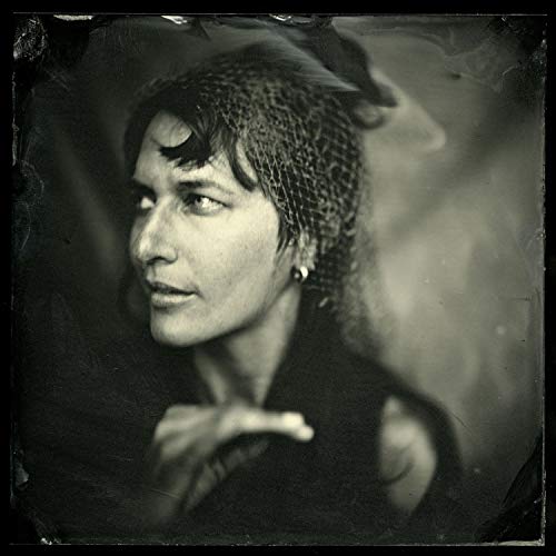 Black and white portrait of Josephine Foster with textured hair.