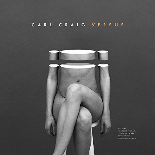 Black and white album cover with a figure sitting on a stool, multiple arms.
