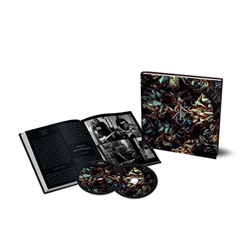 Dark CD packaging with abstract floral design and open booklet with photos.