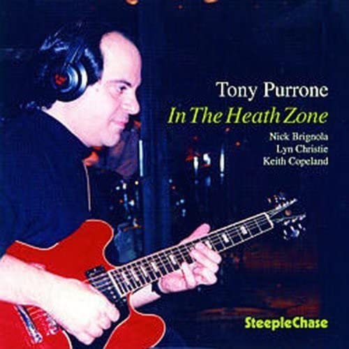 Man with guitar and headphones, album cover for “In The Heath Zone.”
