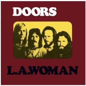 Red album cover with "The Doors" and "L.A. Woman" text, featuring a band photo.
