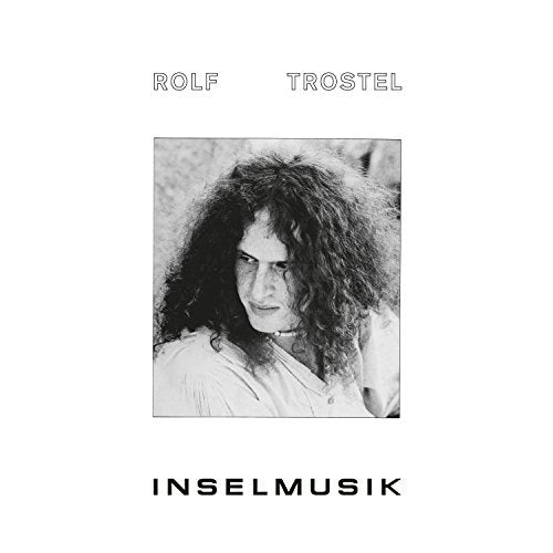 "Album cover with black and white photo of man with long hair."
