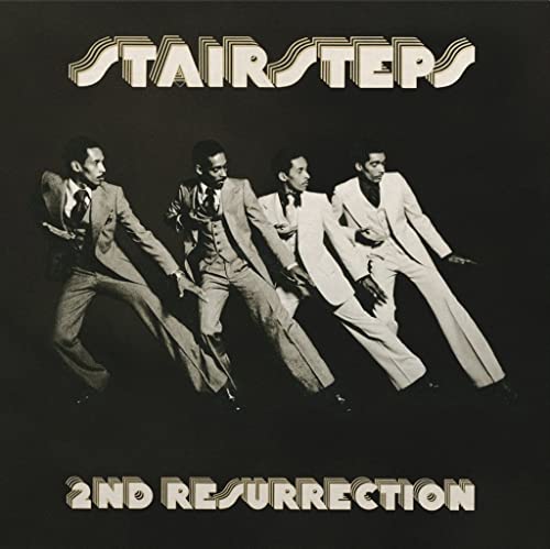 Black and white album cover featuring four men in suits, "Stairsteps" and title.