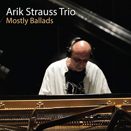 Arik Strauss at a piano with headphones, album cover for "Mostly Ballads".