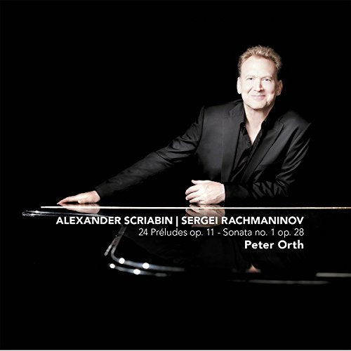 Man in black shirt and jacket leaning on a piano with text overlay.