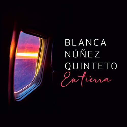 "Album cover with airplane window view of sunset and artist name in white and red text."