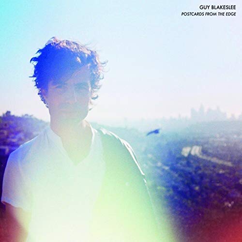 CD cover featuring a blurry portrait of a man against a city backdrop.
