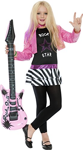 A young girl in a pink and black rockstar costume holding a pink guitar.