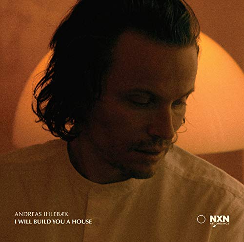 Album cover featuring a man with dark hair and a white shirt.