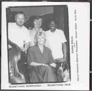 Black and white CD cover featuring four people and a dog.