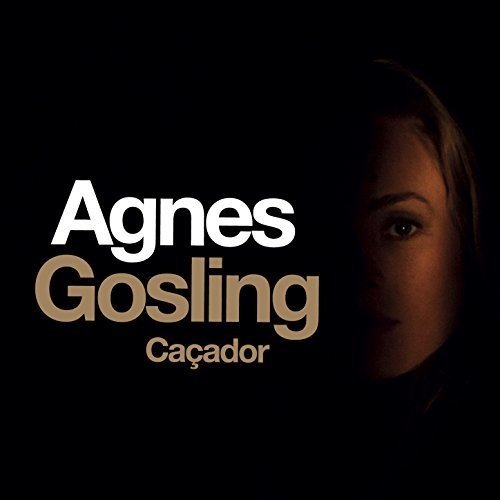 "Album cover with a woman's face partially lit on a black background."