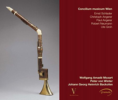 CD cover featuring a dark woodwind instrument against a red background.
