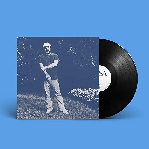 Vinyl record with album cover featuring a man in a field.