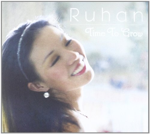 A smiling woman on a CD cover titled "Ruhan - Time To Grow".